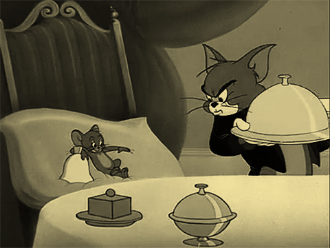 Image of Jerry the Mouse on a comfy cushion. An annoyed Tom is serving him a delicious meal (that's probably a bomb in disguise.)