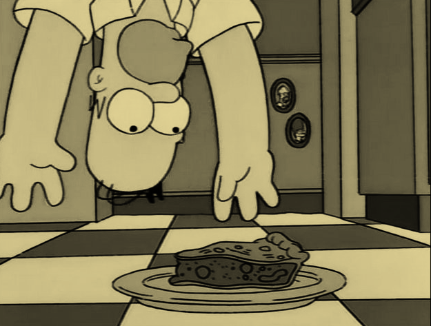 Screengrab of Homer dangling upside-down with a pie on the floor tantalisingly out of reach. D'oh etc.