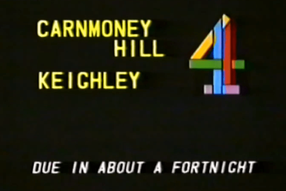 Screencapture: An engineering announcement caption card for Channel 4: "Carnmoney Hill, Keighley - Due in about a fortnight".