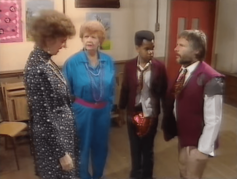 SCREENGRAB: Bill Oddie (okay, William) and a fellow pupil in tattered uniforms are addressed by a teacher.
