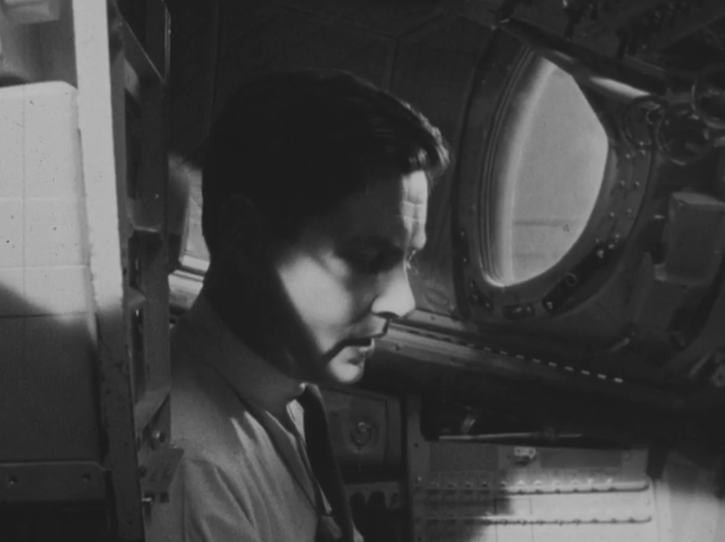 Screencap: David Lutyens sat inside a Gemini spacecraft